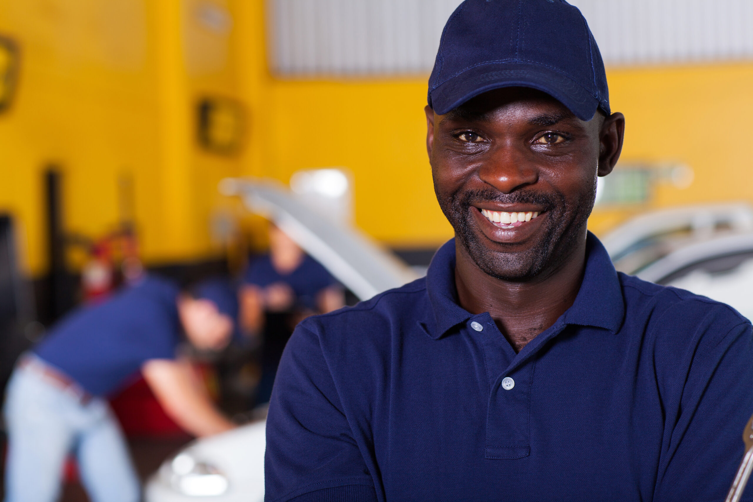 close up portrait of happy african male auto mechanic
